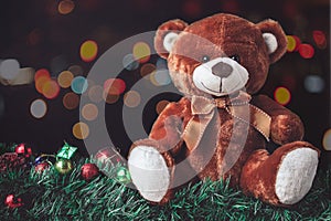 Teddy Bear in Christmas with Ball and Gift Box in Blur Backgroun