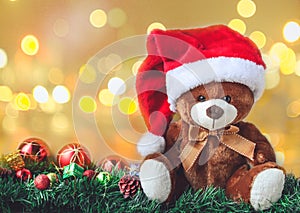 Teddy Bear in Christmas with Ball and Gift Box in Blur Backgroun