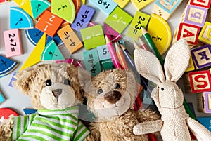 teddy bear close up with pencils, fractions, blocks on the table. activities for kids.