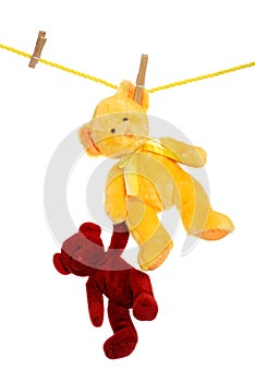 Teddy bear on clothes line rescuing another