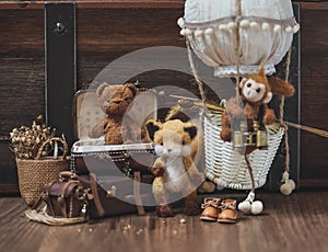 Teddy Bear. Cute miniature dolls made from mo-hair : Teddy Bear, fox and a monkey on the balloon. Vintage film grained filter with