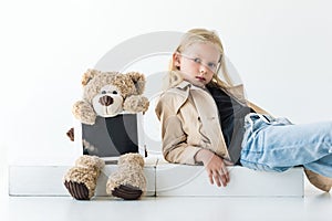 teddy bear with digital tablet and adorable stylish child