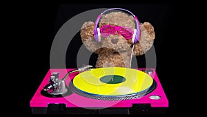 Teddy bear djing on turntables with headphones