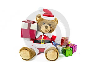 A teddy bear doll wearing santa set, carry gift box  isolated on white background,Christmas day and New Year`s gifts