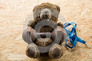 Teddy bear exercise with dumbbell and tape