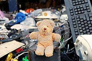 Teddy bear on the garbage pile, Pile of used Electronic and Housewares Waste Division broken or damage