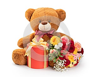 teddy bear with gift and flowers isolated on white background