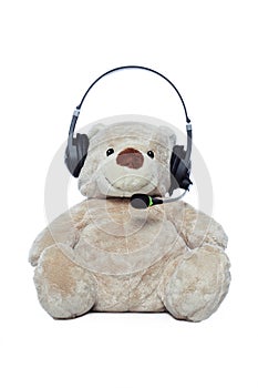 Teddy bear with headset isolated over white