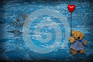 Teddy bear with heart baloon