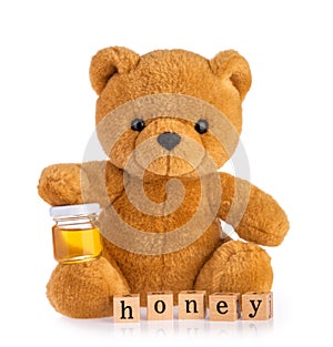 Teddy bear holding honey pot isolated white background