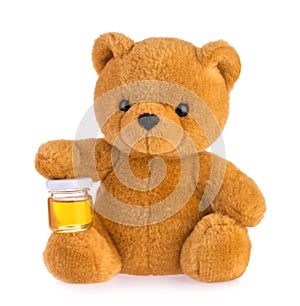 Teddy bear holding honey pot isolated white background
