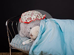 Teddy bear is ill. Seasonal sickness, flu, child care concept.