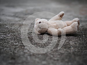 Teddy bear is laying down on the floor. lonely concept. internat