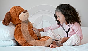 Teddy bear, learning and child with stethoscope for healthcare, heart and anatomy education in her bedroom and home for