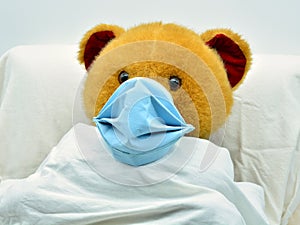 teddy bear with mask, sick of coronavirus in a hospital