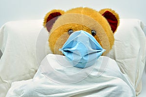 Teddy bear with mask, sick of coronavirus in a hospital photo