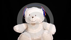 Teddy bear moving with changing headphones