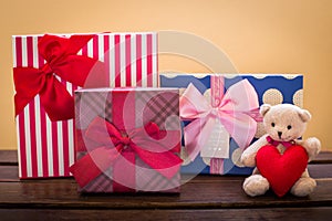 Teddy bear with pink heart decoration on rose and present gift o
