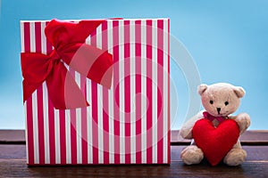 Teddy bear with pink heart decoration on rose and present gift o