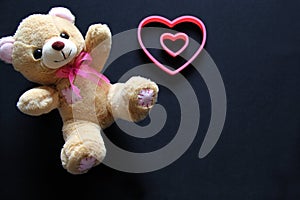 Teddy bear and pink hearts on black background, Valentine`s Day gifts, advertising banner