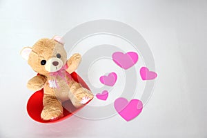 Teddy bear and pink hearts on white background, valentine`s day, advertising baner