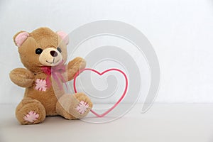 Teddy bear and pink hearts on white background, valentine`s day, advertising baner