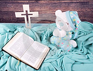 Teddy bear pray whit bible and cross. New Born,communion