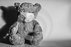 Teddy bear in a protective medical mask.