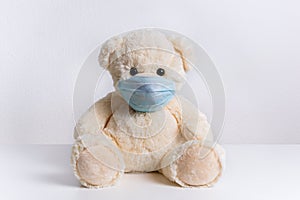 Teddy bear with protective medical mask on his face. Concept of hygiene and virus protection for child patient
