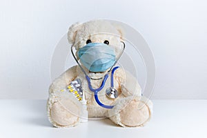 Teddy bear with protective medical mask and stethoscope. Concept of hygiene and virus protection for child patient