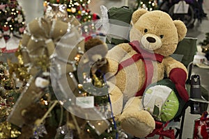 Teddy Bear with a Red Bow Tie Sitting next to a Christmas Tree C