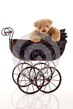 Teddy bear in the retro pram.