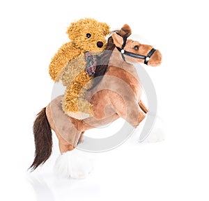Teddy bear riding a horse