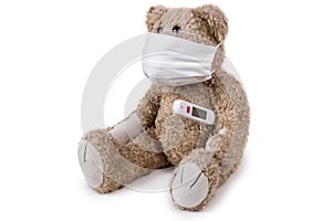 The teddy bear sits ill with a coronavirus in a medical mask