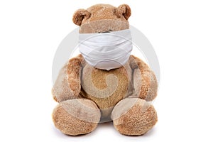 The teddy bear sits ill with a coronavirus in a medical mask