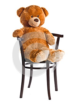 Teddy bear sitting on a chair