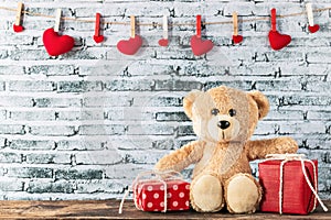 Teddy bear sitting with gift box