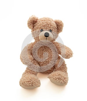 Teddy bear sitting isolated on white background. Cute brown stuffed animal