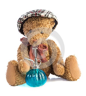 Teddy bear sitting with old vaporizer and cap