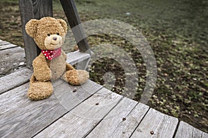 Teddy bear sitting on a pier