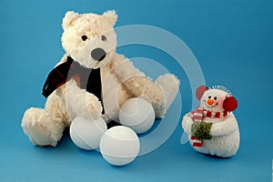 Teddy bear with snowman and snowballs