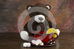 Teddy bear with tea mug on table