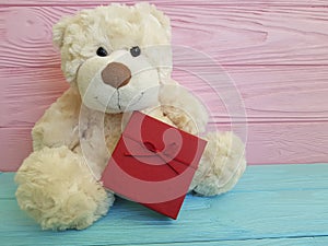 Teddy bear toy on a wooden gift box