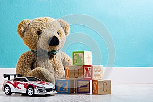 Teddy bear and toys in a baby`s room