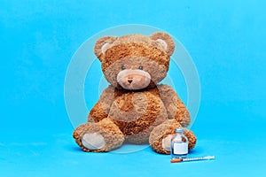 teddy bear with vaccine or medicine and syringe