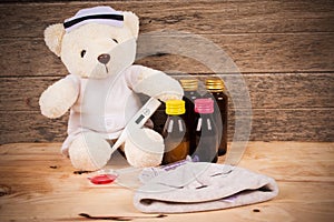 teddy bear wear nurse with thermometer and medicine