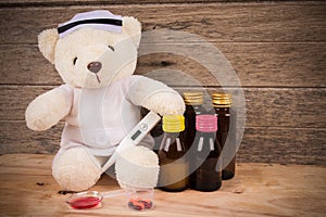 Teddy bear wear nurse with thermometer and medicine