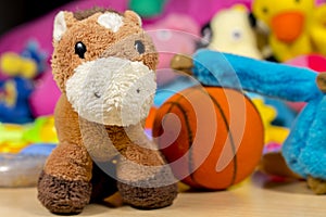 Teddy donkey in front of others baby toys