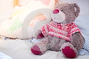 Teddy dream concept: Teddy bear is sitting in the bed