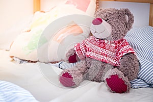 Teddy dream concept: Teddy bear is sitting in the bed